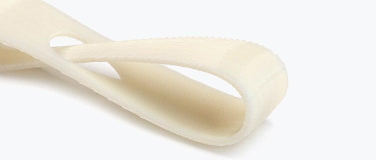 Close-up view of a white 3D-printed loop made from ABS-M30i using fused deposition modeling with a normal finish