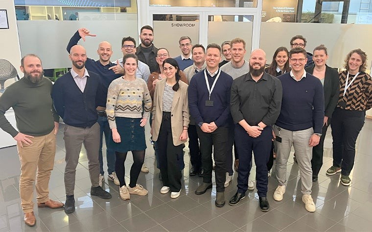 Group photo of the Materialise CMF team in the lobby of Materialise HQ