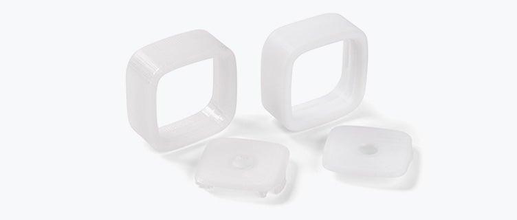 Four white 3D-printed pieces made in PC-ISO using fused deposition modeling.
