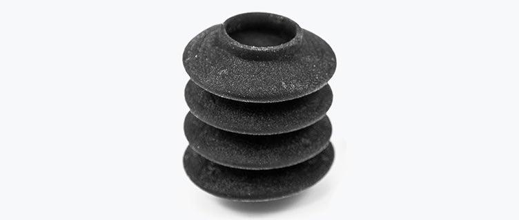 Close-up view of two black 3D-printed bellows made from Agilus using PolyJet