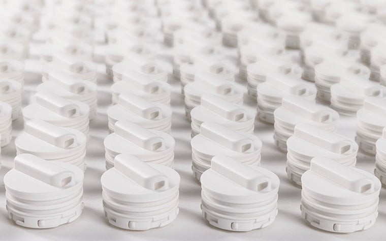 Rows of biocompatible 3D-printed components made for Sartorius using selective laser sintering.
