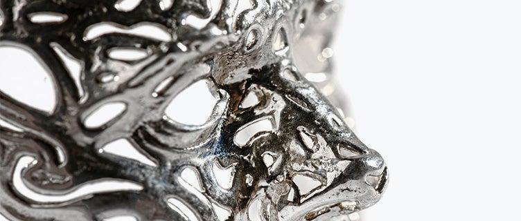 An intricate silver face mask made with lost-wax casting.