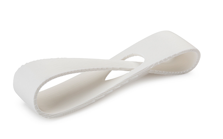 A white 3D-printed loop made from ABS-M30 using fused deposition modeling, with a normal finish.