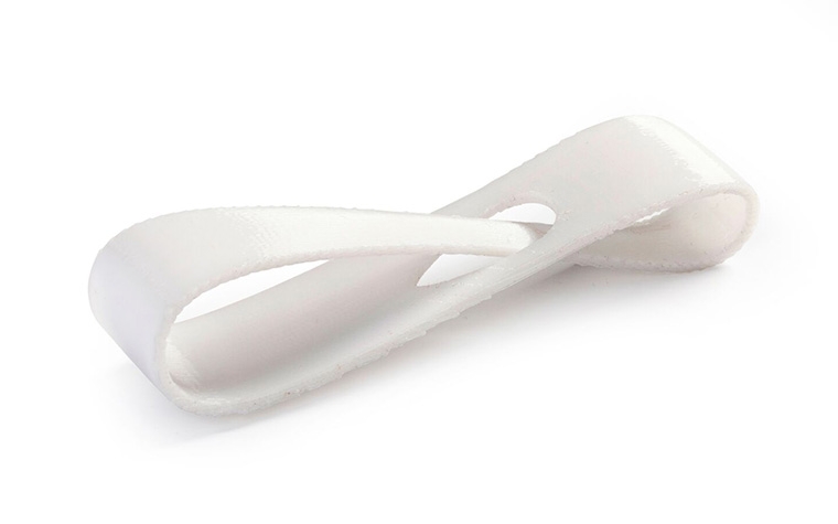 A white loop printed in PC-ISO using fused deposition modeling with a normal finish.