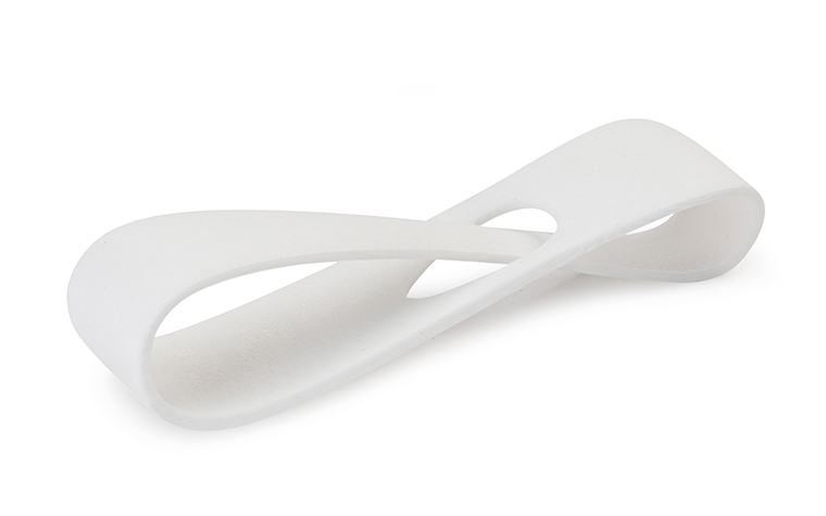A smooth, white sample loop 3D printed in PA-GF using SLS.