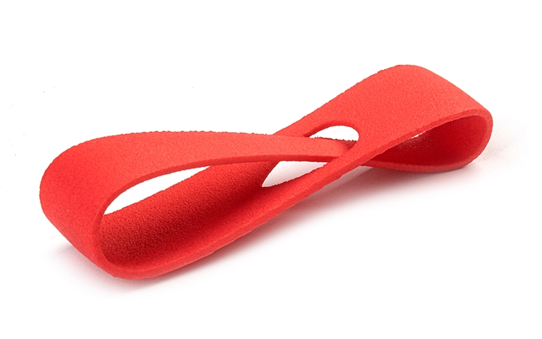 A red 3D-printed loop made from PA 12 using laser sintering, with a color-dyed finish. 