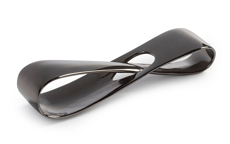 A brass infinity loop made with lost-wax casting and a polished + black color-plated finish.