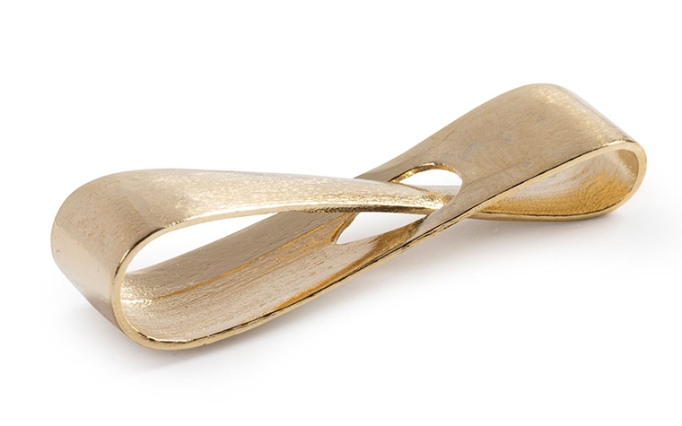 A brass infinity loop made with lost-wax casting and an unpolished finish.