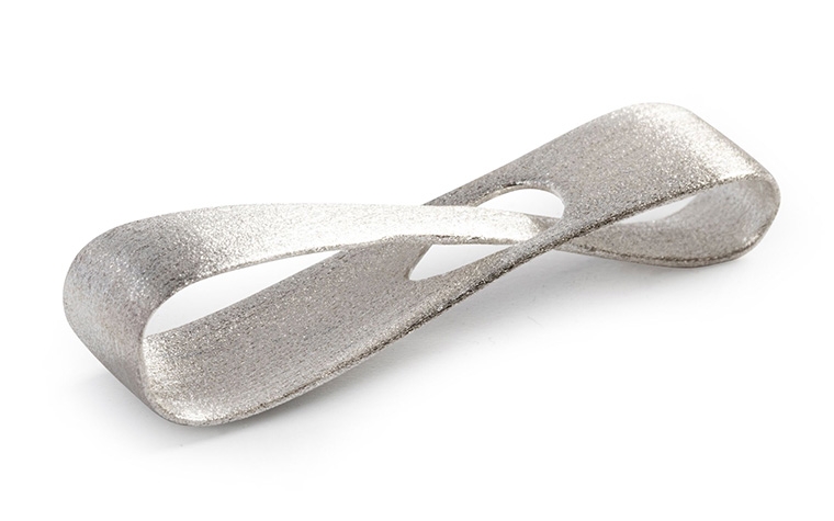 A silver infinity loop made with lost-wax casting and a brushed finish.