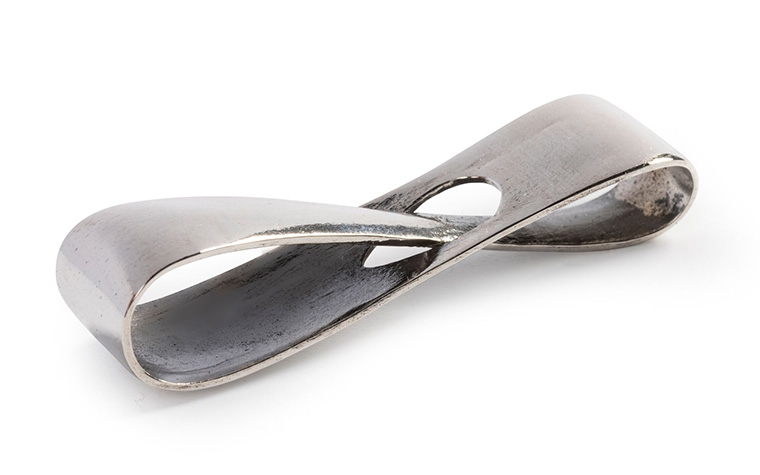 A silver infinity loop made with lost-wax casting and a polished + black patina finish.